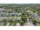 Bird's eye view of a residential neighborhood with mature trees and well-maintained lawns at 15420 Quail Woods Pl, Ruskin, FL 33573