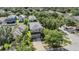 Aerial view of a two-story home featuring mature landscaping and a driveway leading to a two-car garage at 15420 Quail Woods Pl, Ruskin, FL 33573