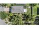 Aerial view of a well-maintained home with a large roof and lush surrounding greenery at 15420 Quail Woods Pl, Ruskin, FL 33573