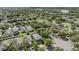 Aerial view of a residential neighborhood showcasing a variety of homes and tree-lined streets at 15420 Quail Woods Pl, Ruskin, FL 33573