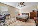 Bedroom featuring a ceiling fan, large window, a neutral color scheme, a work desk and a platform bed at 15420 Quail Woods Pl, Ruskin, FL 33573