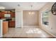 Bright dining area with tile flooring, a pendant light, and access to the kitchen at 15420 Quail Woods Pl, Ruskin, FL 33573