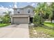 Charming two-story home featuring a two-car garage and well-maintained landscaping at 15420 Quail Woods Pl, Ruskin, FL 33573