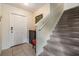 Inviting home foyer with staircase, tile flooring, and a white front door at 15420 Quail Woods Pl, Ruskin, FL 33573
