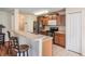 Well-equipped kitchen with stainless appliances, wooden cabinets, and tile flooring at 15420 Quail Woods Pl, Ruskin, FL 33573