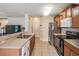 Well-lit kitchen with stainless steel appliances and a breakfast bar open to the living area with tile flooring throughout at 15420 Quail Woods Pl, Ruskin, FL 33573