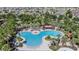 Aerial image of the resort-style community pool featuring lounge chairs, palm trees, and shaded cabanas at 15420 Quail Woods Pl, Ruskin, FL 33573