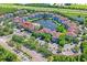 Beautiful aerial view of community with large pond, fountains, a pool, lush greenery, and ample parking at 1640 Villa Capri Cir # 206, Odessa, FL 33556