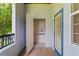 Covered balcony with a wooden floor featuring a storage closet and a pleasant view of lush greenery at 1640 Villa Capri Cir # 206, Odessa, FL 33556
