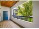 Inviting covered balcony with wooden floor and peaceful views of green trees at 1640 Villa Capri Cir # 206, Odessa, FL 33556