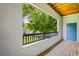 Inviting covered balcony with wooden floor and peaceful views of green trees at 1640 Villa Capri Cir # 206, Odessa, FL 33556