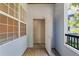 Covered balcony with a wooden floor featuring a storage closet and a pleasant view of lush greenery at 1640 Villa Capri Cir # 206, Odessa, FL 33556