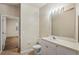 Clean bathroom featuring a toilet, vanity, mirror, and bright lighting at 1640 Villa Capri Cir # 206, Odessa, FL 33556