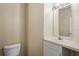 Powder room featuring a white toilet and vanity sink with a mirror at 1640 Villa Capri Cir # 206, Odessa, FL 33556