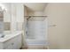 Neutral bathroom featuring a white shower-tub combination and a vanity sink with a large mirror at 1640 Villa Capri Cir # 206, Odessa, FL 33556