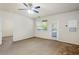 Well-lit bedroom with a ceiling fan, balcony access, and neutral carpet at 1640 Villa Capri Cir # 206, Odessa, FL 33556