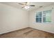 Cozy bedroom with neutral carpet, a ceiling fan, and a bright window at 1640 Villa Capri Cir # 206, Odessa, FL 33556