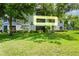 Apartment building with lawn, greenery, and trees from an exterior view at 1640 Villa Capri Cir # 206, Odessa, FL 33556