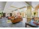 Spacious clubhouse featuring tile floors, sofas, a fireplace, and a bar area at 1640 Villa Capri Cir # 206, Odessa, FL 33556