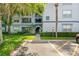 Condo exterior view features manicured landscaping, an exterior stairwell, and a clearly marked parking area at 1640 Villa Capri Cir # 206, Odessa, FL 33556