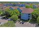 Exterior angle view of the condo building showing two stories and ample parking in a well-maintained community at 1640 Villa Capri Cir # 206, Odessa, FL 33556
