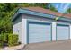 A single light-blue, paneled garage door with neutral stucco walls and brown roof at 1640 Villa Capri Cir # 206, Odessa, FL 33556