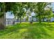 Community green space with well maintained lawn, mature shade trees, picnic tables, and complex in background at 1640 Villa Capri Cir # 206, Odessa, FL 33556