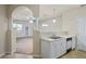 Well-lit kitchen featuring a double sink, dishwasher, and view to the living room at 1640 Villa Capri Cir # 206, Odessa, FL 33556
