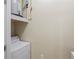 Functional laundry area with a washing machine, water heater, and storage at 1640 Villa Capri Cir # 206, Odessa, FL 33556