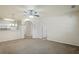 Spacious living room with neutral carpet, fan, and view of the open floor plan at 1640 Villa Capri Cir # 206, Odessa, FL 33556