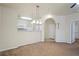 Inviting living area with plush carpet, open access to kitchen, and modern light fixtures at 1640 Villa Capri Cir # 206, Odessa, FL 33556