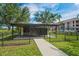 Mailbox structure featuring black mailboxes, a black metal fence, and a concrete walkway at 1640 Villa Capri Cir # 206, Odessa, FL 33556