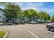 Parking lot view showcasing parking spaces with several parked cars outside the apartment building at 1640 Villa Capri Cir # 206, Odessa, FL 33556