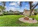 Sprawling backyard featuring a brick fire pit area and lush green lawn at 1810 Tamerlane Pl, Brandon, FL 33510