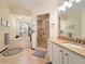 Bathroom featuring tiled step-in shower, large bathtub, vanity, and ample mirrors at 1810 Tamerlane Pl, Brandon, FL 33510