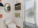 Bathroom with toilet, shelving, a vanity and mirror, window and wall decor at 1810 Tamerlane Pl, Brandon, FL 33510