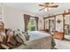 Bright bedroom featuring a ceiling fan, closet with mirrors and a window with backyard views at 1810 Tamerlane Pl, Brandon, FL 33510