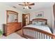 Bedroom features a comfortable bed, dresser, and a view to the connecting rooms at 1810 Tamerlane Pl, Brandon, FL 33510