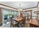 Elegant dining room with chandelier, hardwood floors, and sliding glass doors leading to a screened-in patio at 1810 Tamerlane Pl, Brandon, FL 33510