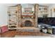 Cozy brick fireplace with built-in shelving and stylish decor accents for a warm and inviting atmosphere at 1810 Tamerlane Pl, Brandon, FL 33510