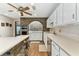 Bright kitchen featuring a brick accent wall, stainless steel appliances, and ample counter space at 1810 Tamerlane Pl, Brandon, FL 33510
