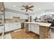 Open kitchen with white cabinets, stainless appliances, and a brick island, flowing into the living space at 1810 Tamerlane Pl, Brandon, FL 33510