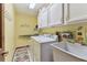 Efficient laundry room with washer, dryer, sink, and ample storage space at 1810 Tamerlane Pl, Brandon, FL 33510