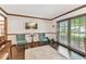 Comfortable living room with hardwood floors, plush rug, and plenty of natural light from large windows at 1810 Tamerlane Pl, Brandon, FL 33510