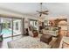 Spacious living room with an open layout, connecting the indoor living space to the outdoor pool area at 1810 Tamerlane Pl, Brandon, FL 33510