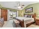 Comfortable main bedroom with wood furnishings, ceiling fan, and sliding glass doors to the outside at 1810 Tamerlane Pl, Brandon, FL 33510
