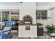 Outdoor covered patio area featuring a brick fireplace and a view of the screened-in pool at 1810 Tamerlane Pl, Brandon, FL 33510