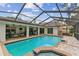 Large screened-in pool with a patio area and a view of the home's exterior under blue skies at 1810 Tamerlane Pl, Brandon, FL 33510