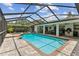 Inviting screened-in pool area featuring a sparkling blue pool, covered patio, and ample space for relaxation at 1810 Tamerlane Pl, Brandon, FL 33510