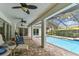 The screened in pool features a covered patio, ceiling fans and views of the sky and trees at 1810 Tamerlane Pl, Brandon, FL 33510